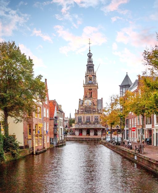 Alkmaar canal and Waaggebouw weigh house tower at dusk, the historic heart of the Dutch cheese market