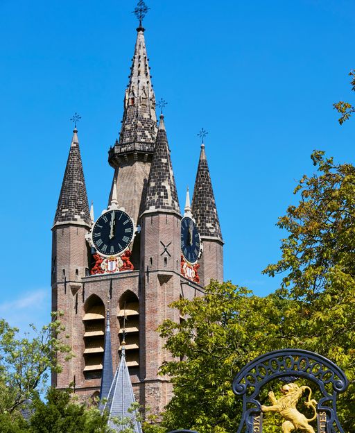 The tower of the Old Church and the Prinsenhof entrance in Delft, Netherlands