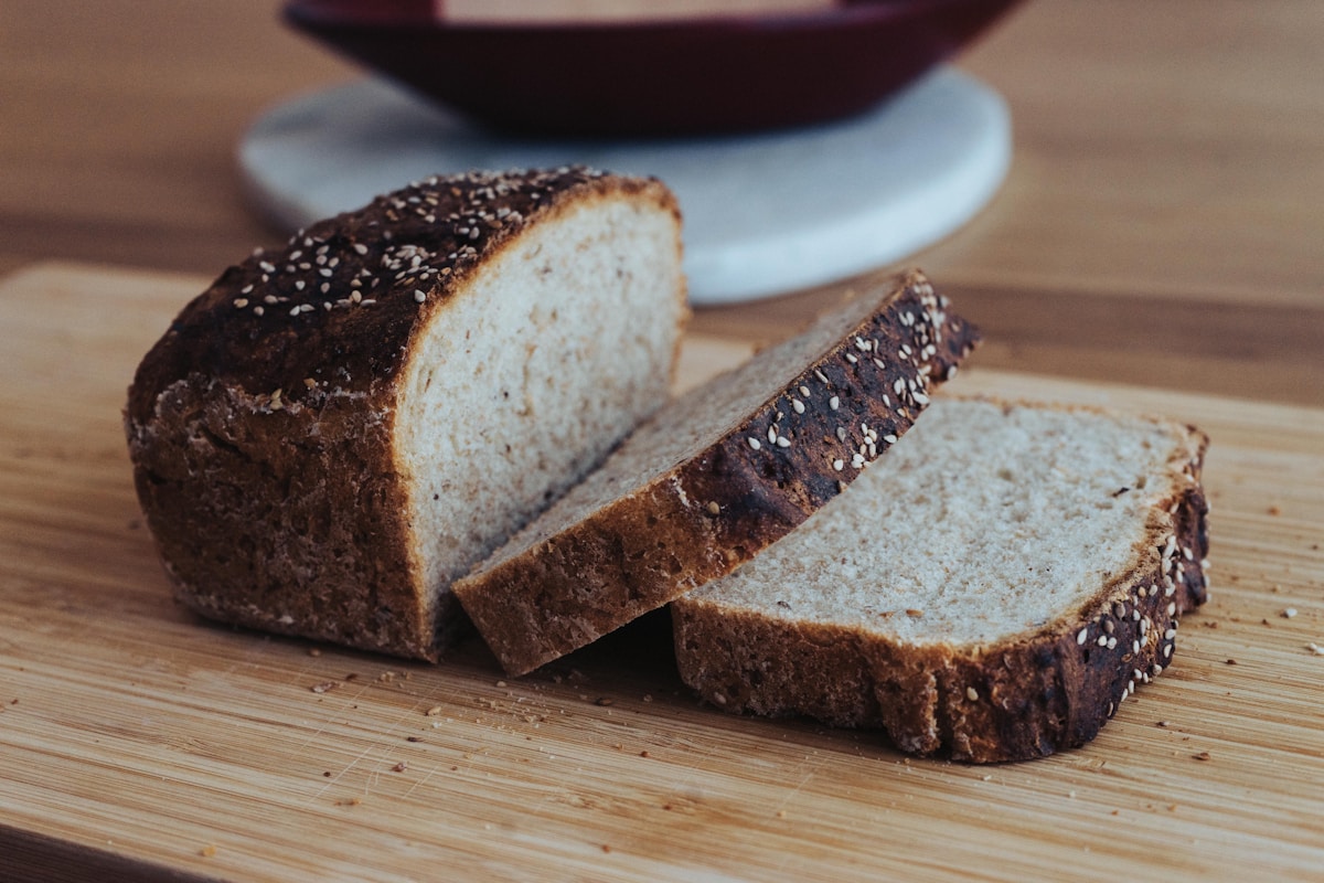Sliced seeded Dutch bread on a wooden board