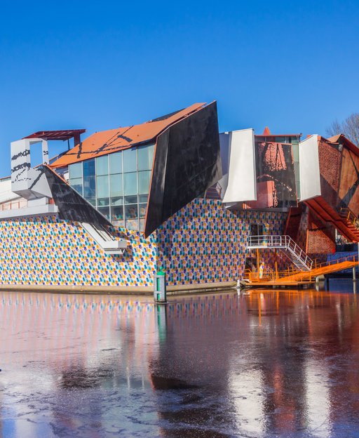 The Groninger Museum, a colourful postmodernist building reflected in the water in Groningen, the Netherlands