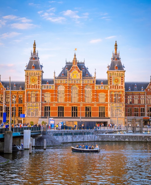 Amsterdam Centraal train station at sunset, the Netherlands