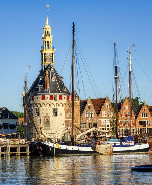 Historic Hoofdtoren tower and tall ships in the harbour of Hoorn, North Holland, Netherlands