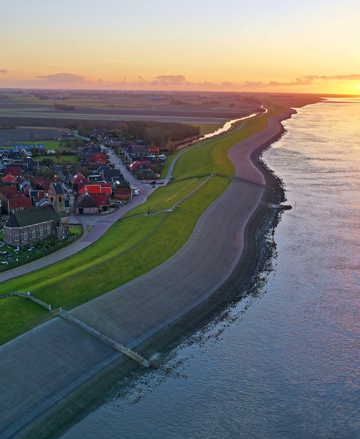 Aerial sunset view of Wierum village on the Wadden Sea coast in Friesland, the Netherlands