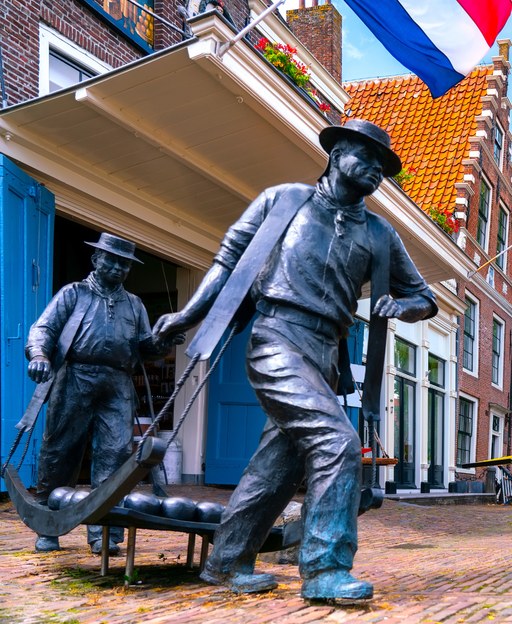 Cheese carriers in traditional white linen outfits at the historic Edam cheese market in the Netherlands
