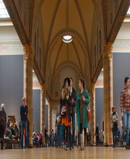 Visitors walking through the Gallery of Honour at the Rijksmuseum Amsterdam