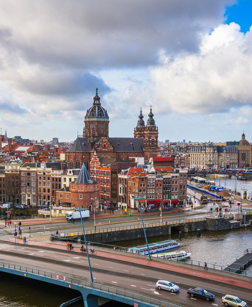The iconic skyline of Amsterdam with the Basilica of Saint Nicholas โ the Netherlands offers a world-class quality of life for American retirees
