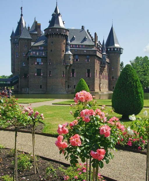 Kasteel de Haar near Utrecht, a red-brick Dutch castle with towers, a moat and a rose garden in the foreground